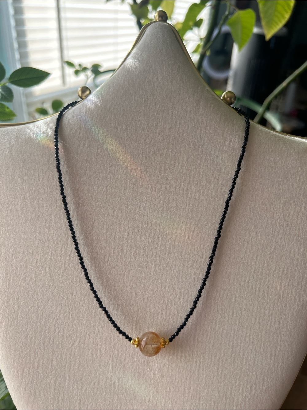 Black spinel beaded necklace with gold accents and a central citrine bead